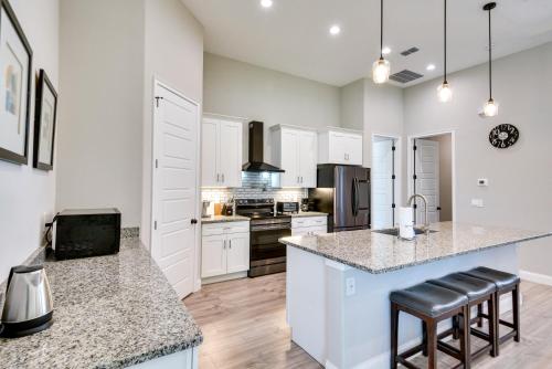a kitchen with white cabinets and a counter top at Palm Coast Family Retreat with Private Pool! in Palm Coast