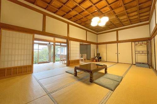 a room with a table in the middle of a room at Koyasan Shukubo Jokiin in Koyasan