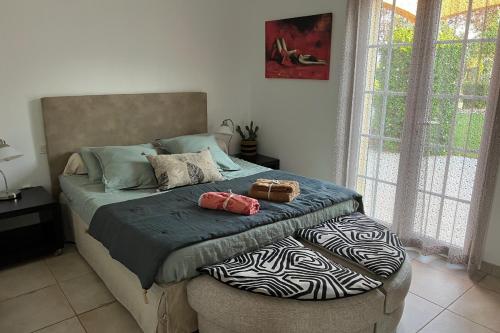 une chambre avec un lit avec deux sacs dessus dans l'établissement LAcacia, à Plaissan