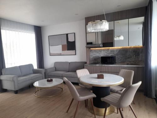 a living room with a couch and a table and chairs at Hotel Nature Bromo and Resort in Pasuruan