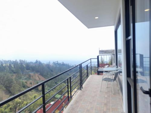 a balcony of a house with a view at Hotel Nature Bromo and Resort in Pasuruan