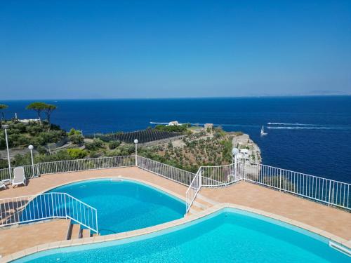 a swimming pool with a view of the ocean at Villaggio Villa Lubrense in Massa Lubrense