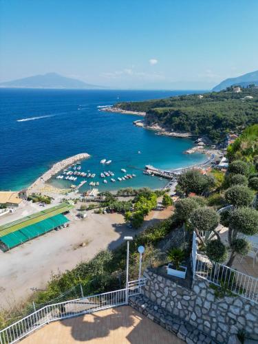 a view of a beach with boats in the water at Villaggio Villa Lubrense in Massa Lubrense