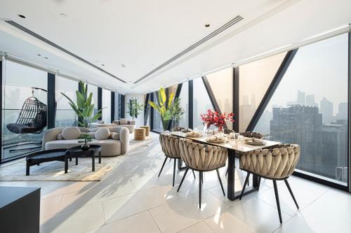 a dining room with a view of the city at Magnificent 3BR Spectacular Canal & Burj View in Dubai