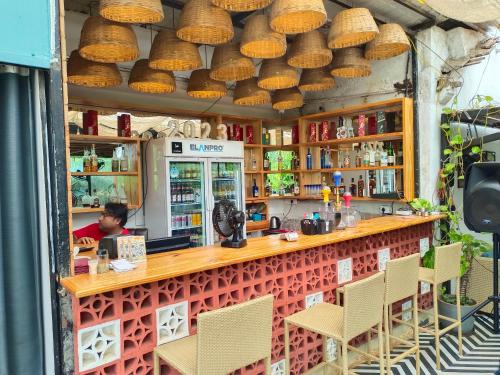 a man sitting at a bar in a restaurant at South Delhi restaurant and resort in Vagator