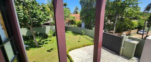 een balkon met uitzicht op een tuin bij Jes Villa in Panadura