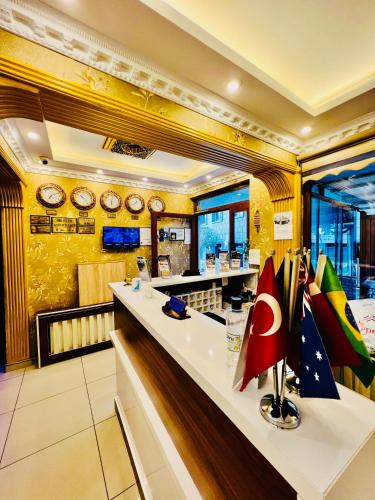 a restaurant with a counter with clocks on the wall at Liman Hotel in Istanbul