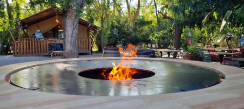 a fire pit in the middle of a patio at Lodges & Nature - 49 in Avignon
