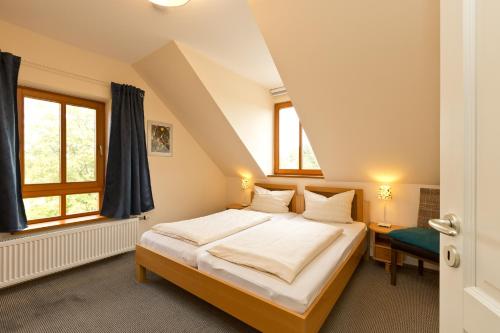 a bedroom with a large bed in a attic at Haus Sarah 4 Am Lorenweg 10 in Göhren-Lebbin