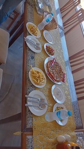 a table with plates of food on top at New venecia resort in Ain Sokhna