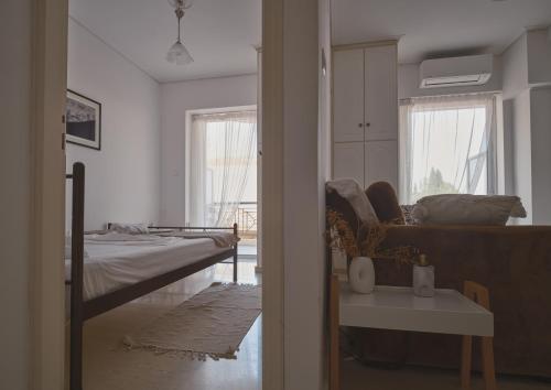 a living room with a bed and a couch at tripoli center apartment in Tripolis