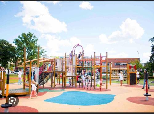 a park with a playground with a slide at Basement apartment in Sandefjord