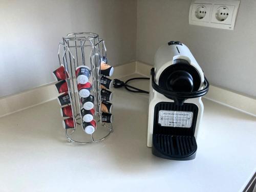 a blender on a counter next to a rack of wine bottles at Apartamento El Espigón (Cimadevilla) in Gijón