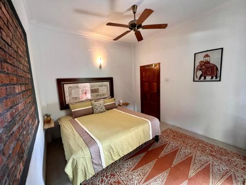 a bedroom with a bed and a ceiling fan at Eagleye Langkawi in Tanjung Rhu