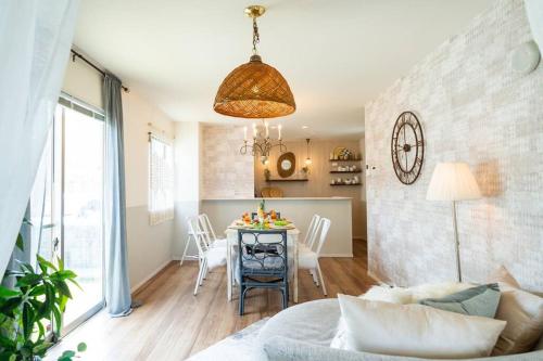 een woonkamer met een tafel en een eetkamer bij Sun flower in Nanjo