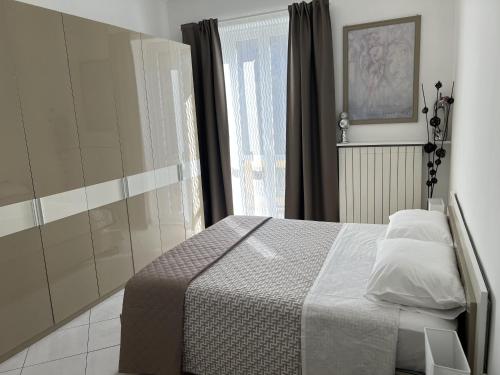 a bedroom with a bed and a window at Lingotto35 in Turin