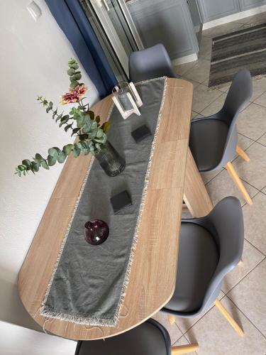 a wooden table with a vase with a plant on it at Bayview Bliss in Mírton