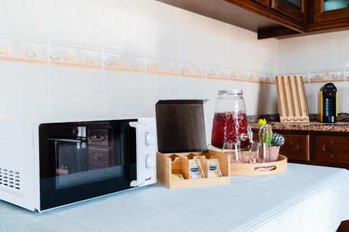 a microwave oven sitting on top of a kitchen counter at A Casa da Marina - Sitio in Nazaré