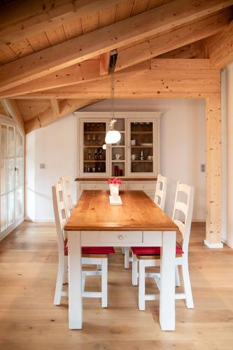 a wooden table and chairs in a room at Landhaus Constantin Luxus-Appartments in Berchtesgaden
