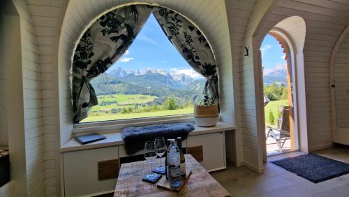 a room with a large window with a view of mountains at Igluhut Four Seasons in Pfarrwerfen