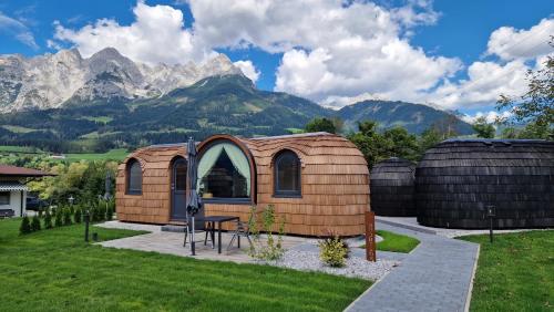 a tiny house with mountains in the background at Igluhut Four Seasons in Pfarrwerfen
