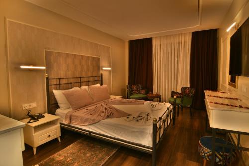 a bedroom with a large bed in a room at SUR PALACE OTEL in Diyarbakır