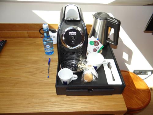 a coffee maker sitting on top of a table at Pensión O Códice in Santiago de Compostela