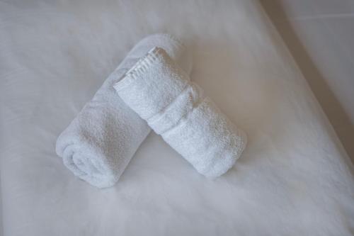 un par de calcetines blancos sentados en una cama en Hotel Constantin, en Trier