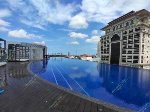 a large swimming pool on the roof of a building at Diamond@Troika in Kota Bharu