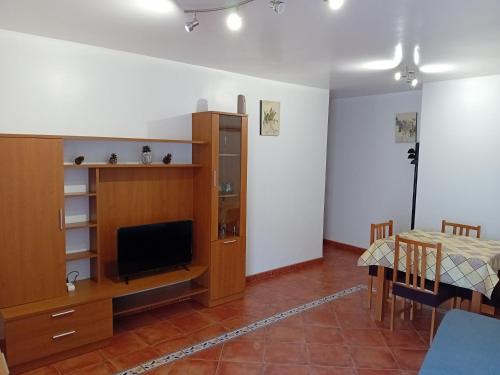 a living room with a television and a dining room at Lovely y Cozy Apartments in Chulilla