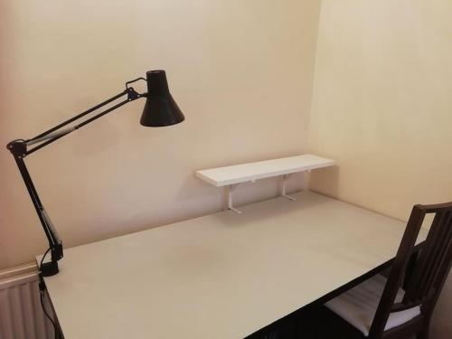 a desk with a lamp and a chair in a room at Millfields cottage and garden in Goxhill