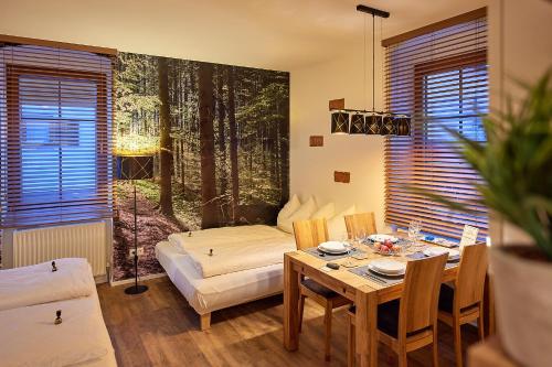 a living room with a table and a bed at Villa Ganzstein in Mürzzuschlag