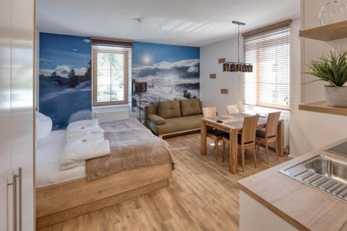 a bedroom with a bed and a dining room at Villa Ganzstein in Mürzzuschlag