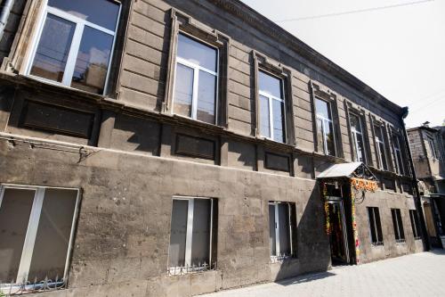 an old building with windows on a street at Hotel Tigran Mets Yerevan in Yerevan