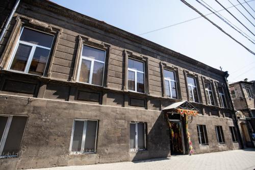 an old building with windows on a street at Hotel Tigran Mets Yerevan in Yerevan