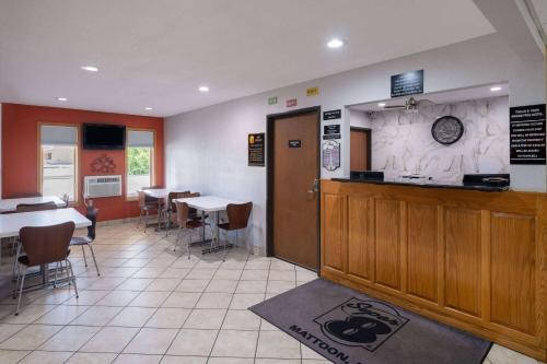 a restaurant with a counter and tables and chairs at Super 8 by Wyndham Mattoon in Mattoon