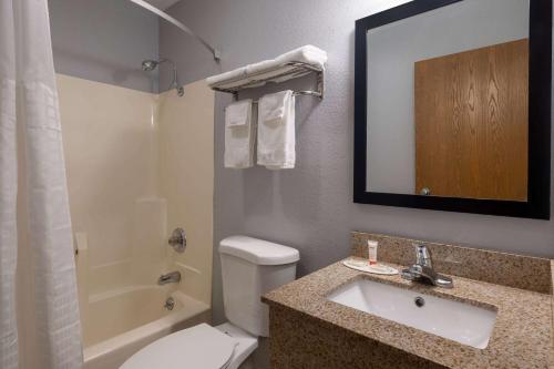 a bathroom with a toilet and a sink and a shower at Super 8 by Wyndham Mattoon in Mattoon