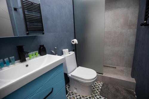 a bathroom with a white toilet and a sink at Hotel Tigran Mets Yerevan in Yerevan