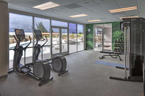 a gym with treadmills and ellipticals in a building at DoubleTree by Hilton Modesto in Modesto