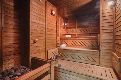 a sauna with wooden walls and wooden flooring at DoubleTree by Hilton Hotel Cluj - City Plaza in Cluj-Napoca
