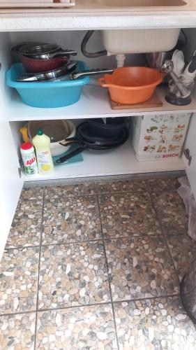 a kitchen shelf with dishes and utensils at Popasul Dacilor in Predeluţ