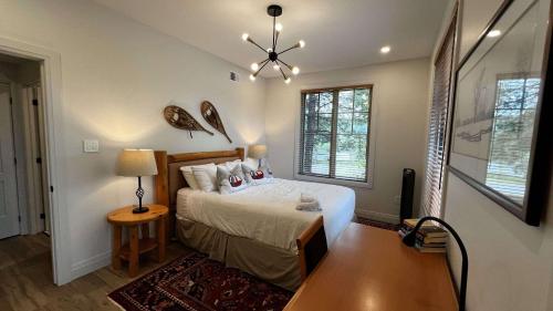 a bedroom with a bed and a chandelier at Calabogie Peaks Hotel, Ascend Hotel Member in Calabogie
