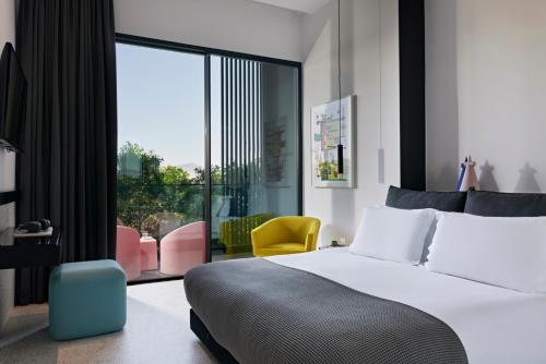 a hotel room with a bed and a large window at MAP Boutique Hotel in Nicosia
