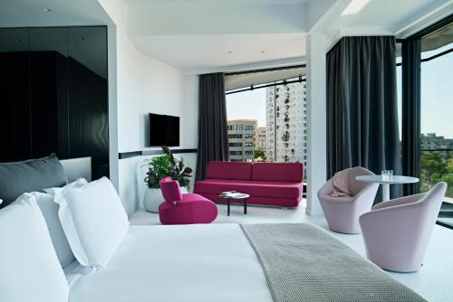 a hotel room with a large bed and a couch at MAP Boutique Hotel in Nicosia