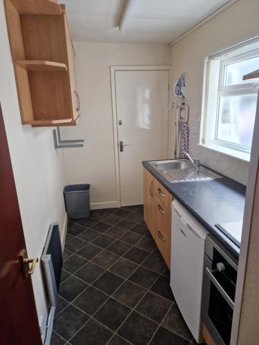 a small kitchen with a sink and a window at Vance House in Blackpool