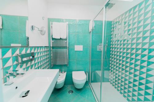 a bathroom with a toilet and a sink and a shower at Hotel Miramare in Maiori