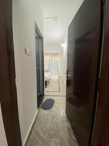 a hallway with a door leading to a living room at Karma Hostel in Khajurāho