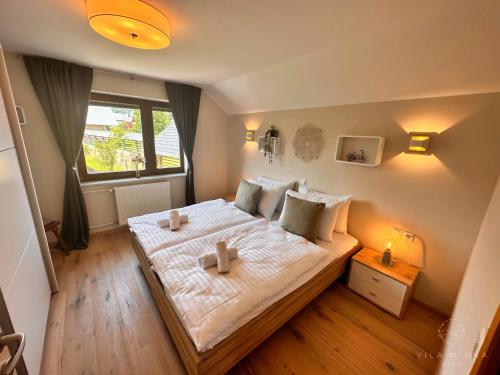 a bedroom with a bed with two candles on it at Vila Minka Bled - Perfect Family Vacation Home in Bled