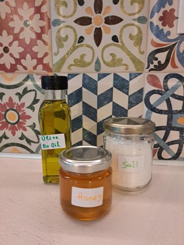 two jars of honey and salt sitting on a shelf at Varsamos in Yiannioú