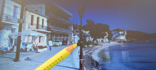 a large yellow inflatable bat on the side of a street at Epavli Sofia' s two Apartments in Horto, 30m from the sea in Chorto
